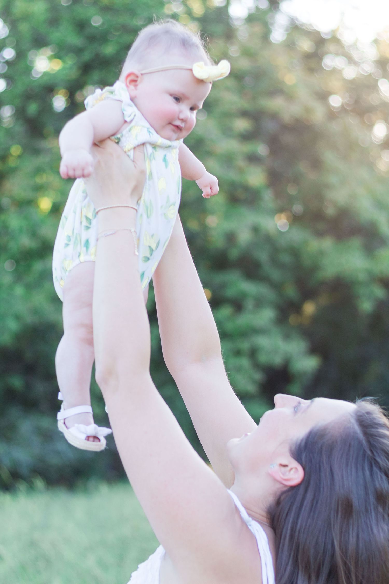 Mother lifting baby in the air