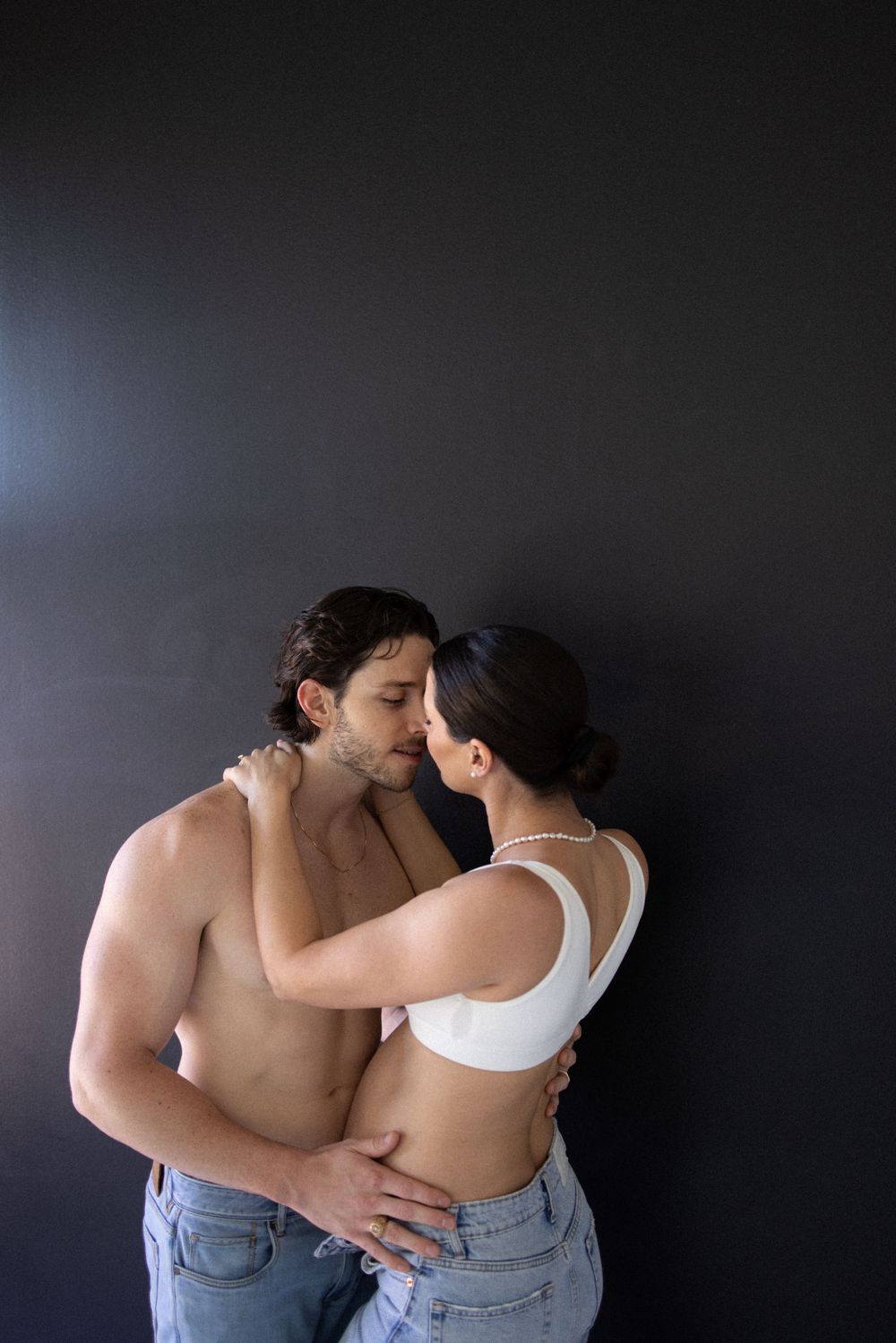Romantic couple photography series with dramatic lighting and intimate poses.