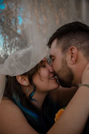 Virginia wedding photography of couple smiling outdoors under veil