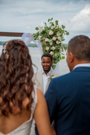 Groom, seeing bride for the first time as she walks down the aisle
