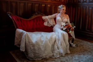 Bride on vintage red sofa in Virginia