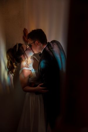 Husband and wife kissing with colorful window colors