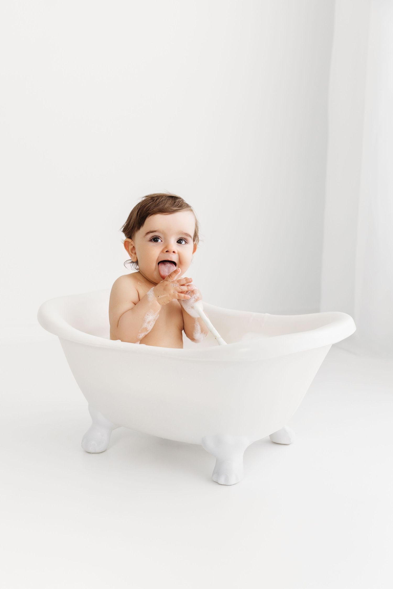 Baby Boy in Clawfoot Bathtub, chewing on a white spoon