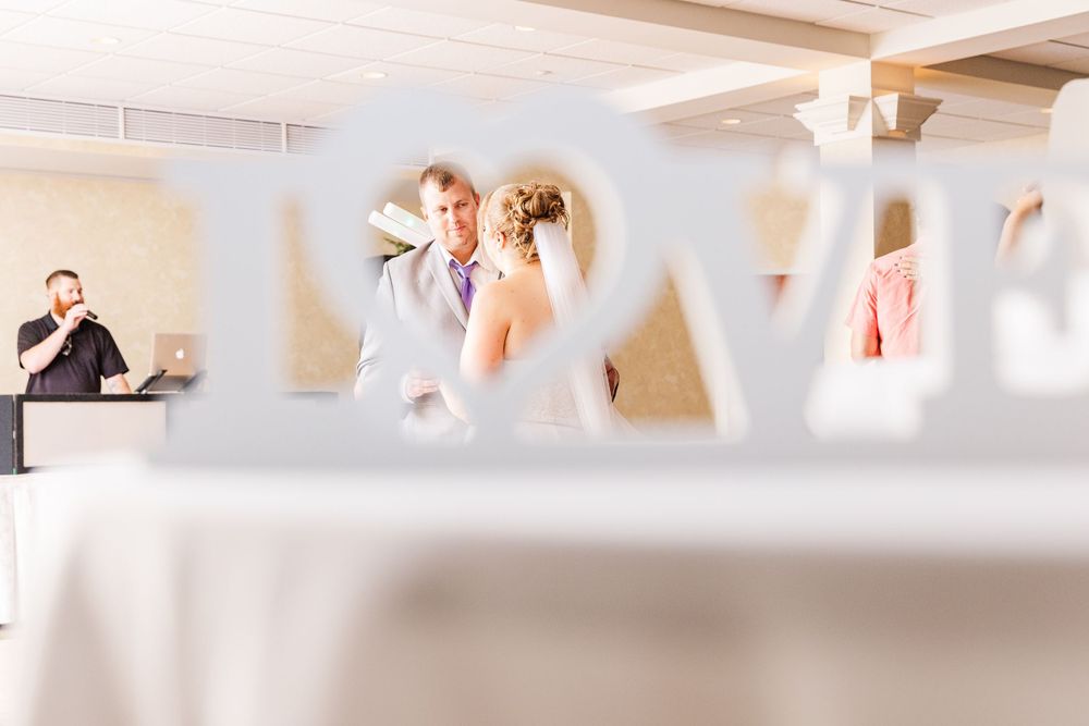A romantic dance scene captured through architectural details at an elegant reception venue.