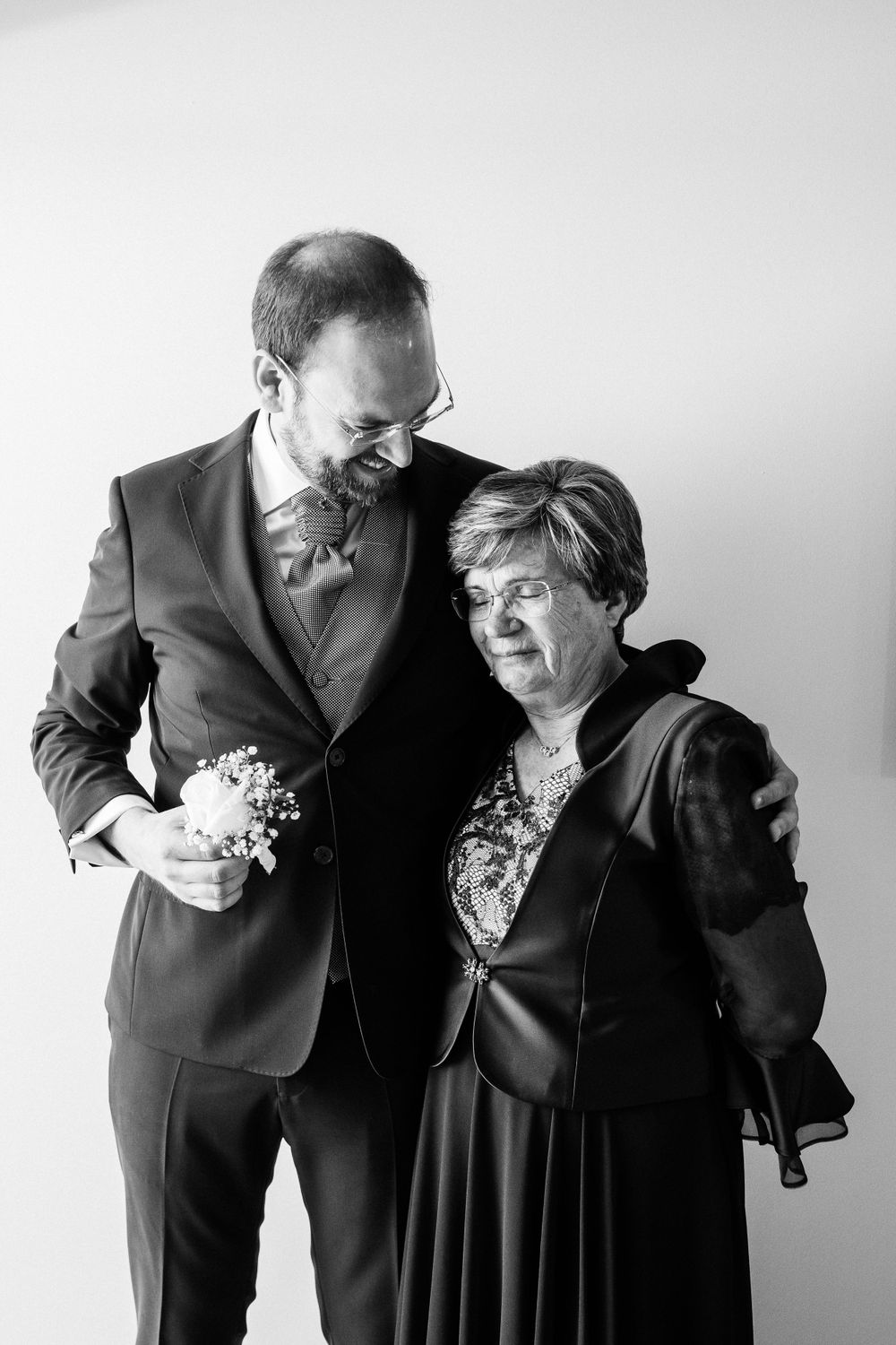 A heartwarming moment between two people at a formal event.