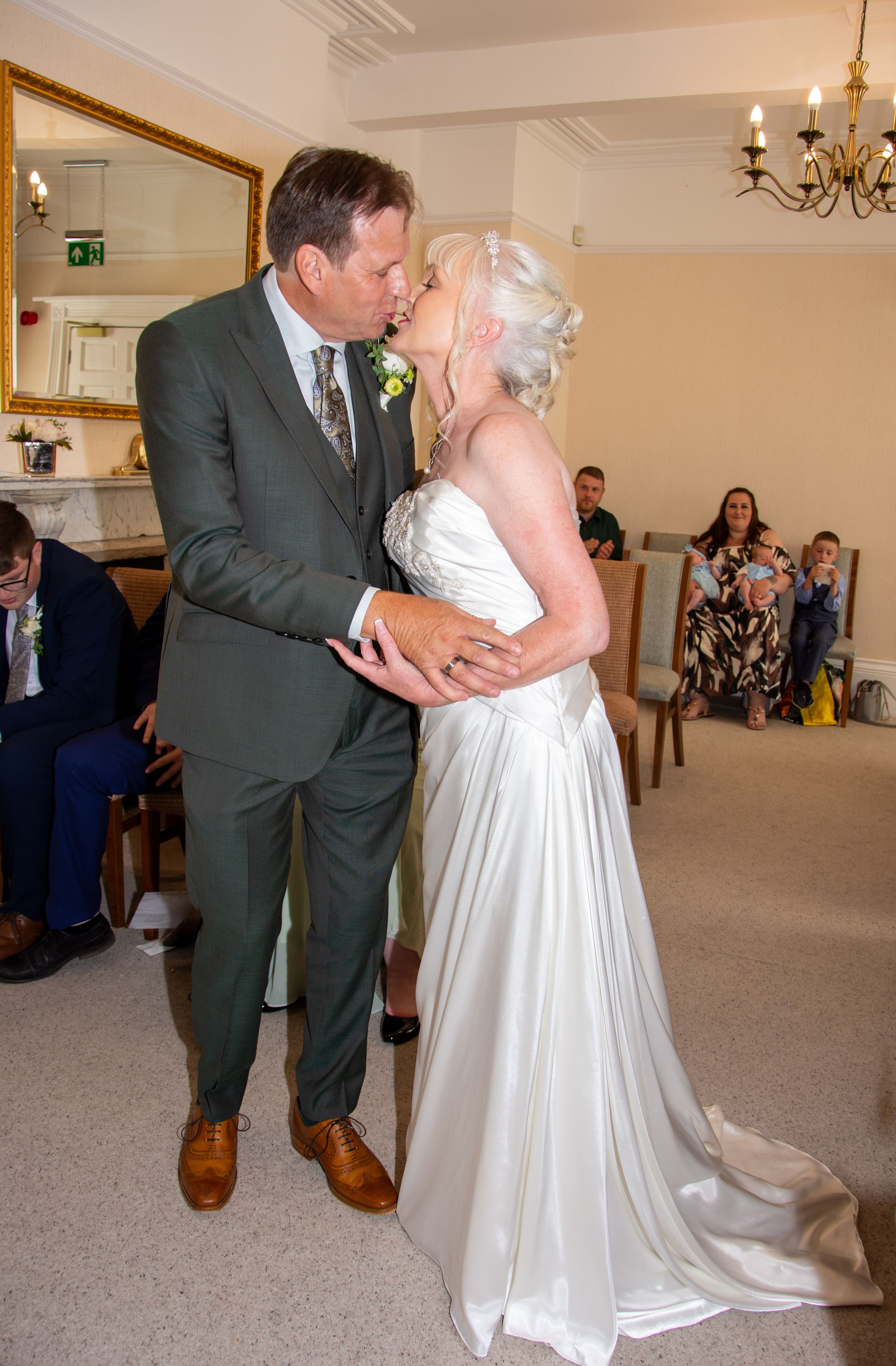 A couple sharing a romantic dance moment during their wedding celebration indoors.