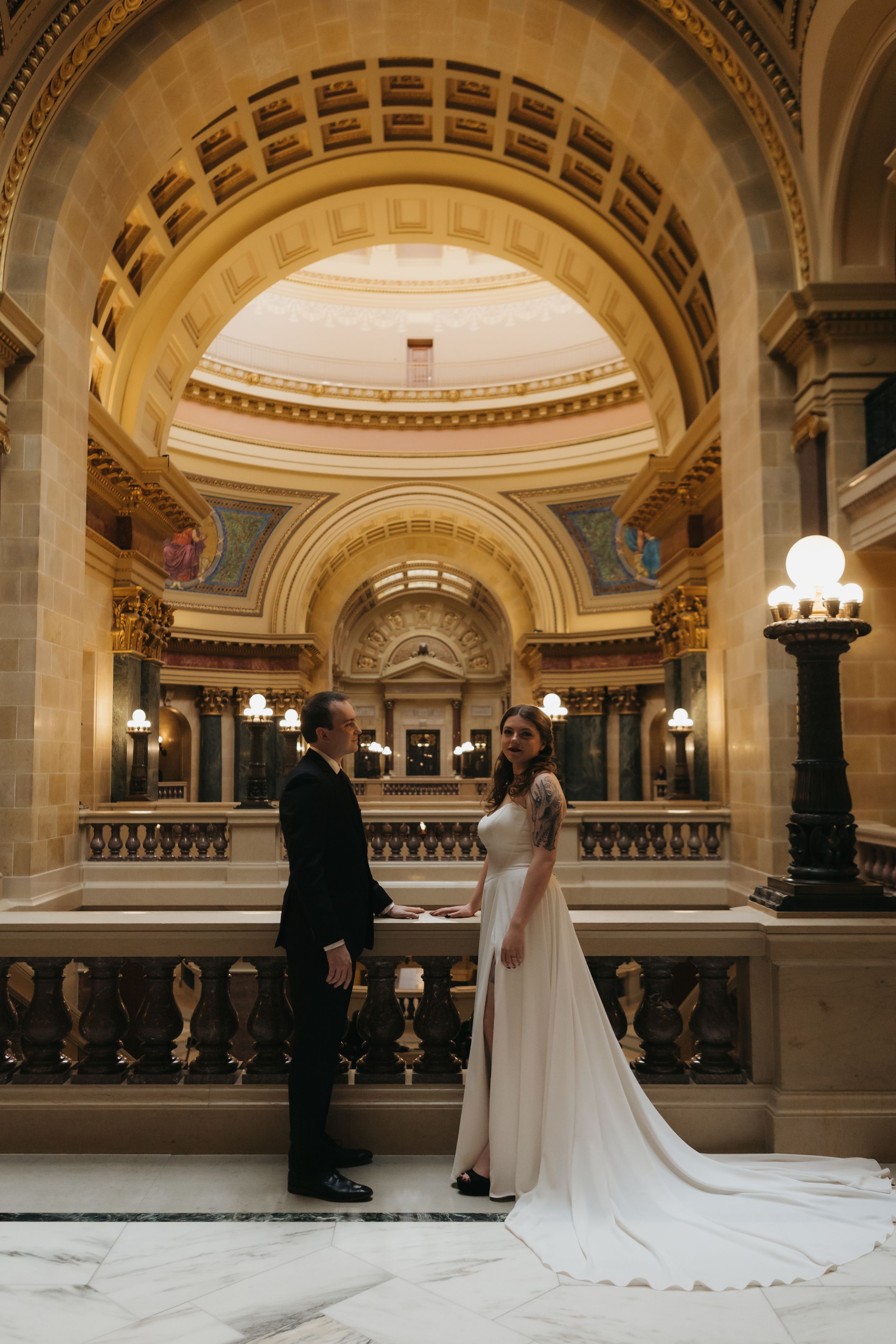 Bride and groom standing together during a wedding ceremony in an elegant historic venue.