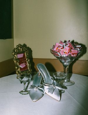 Vintage-style glassware and candy arrangements on a white tablecloth.