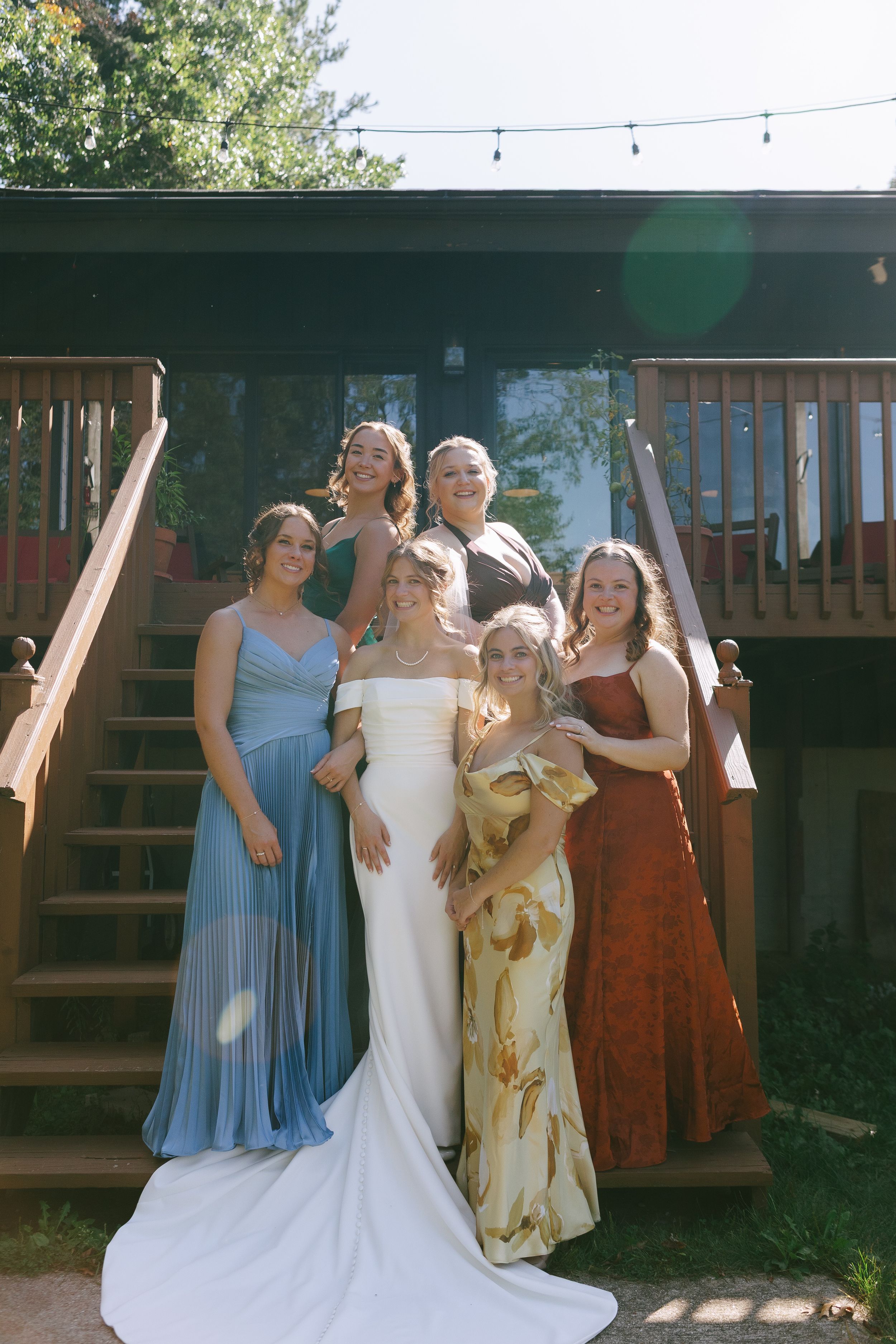 Bride and bridesmaids embracing the sun before the wedding ceremony.