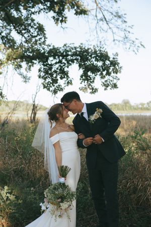 Bride and groom sharing an intimate moment during an outdoor wedding portrait session.