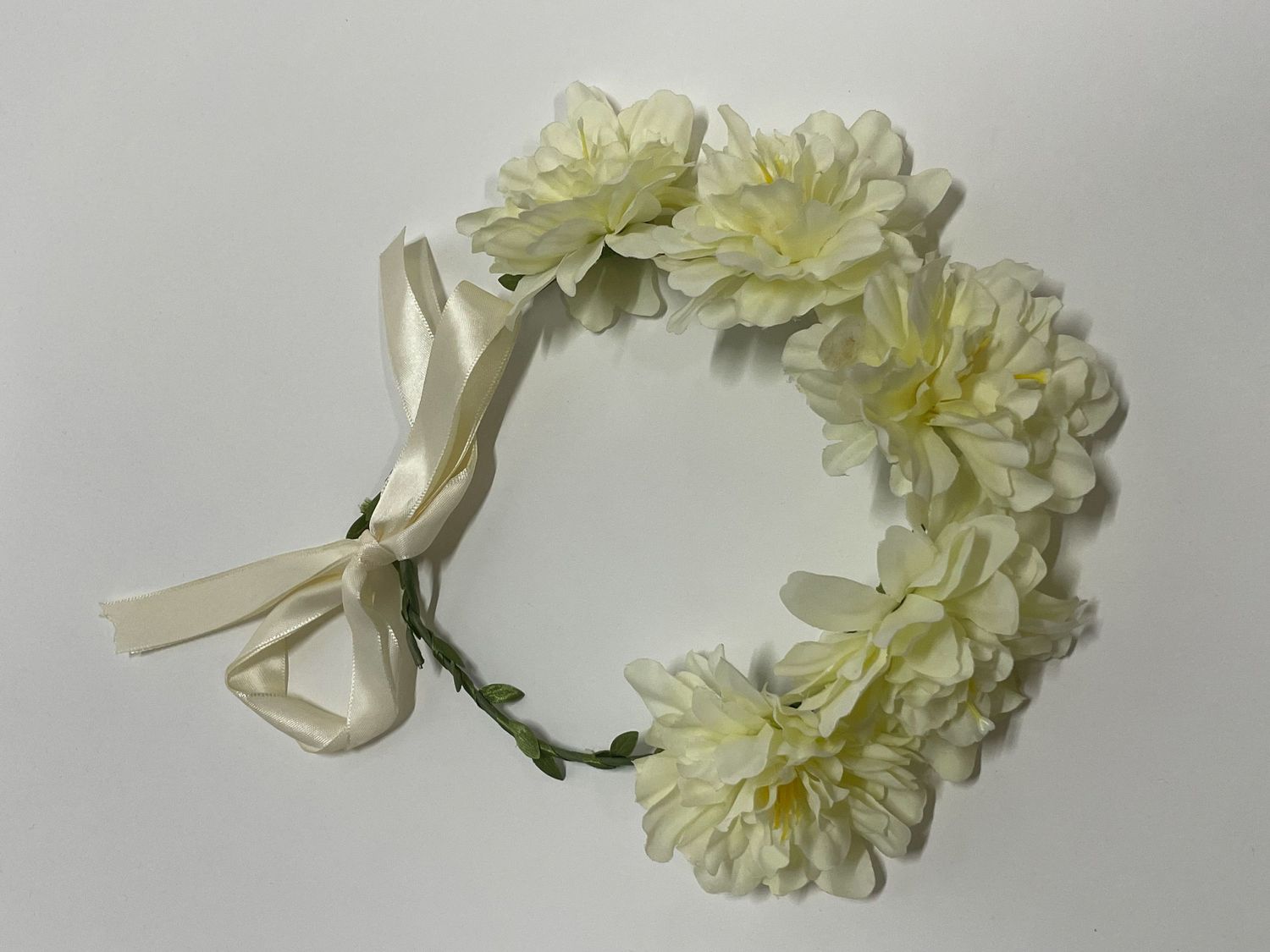 Cream-colored floral crown with pale yellow chrysanthemums and ribbon bow.