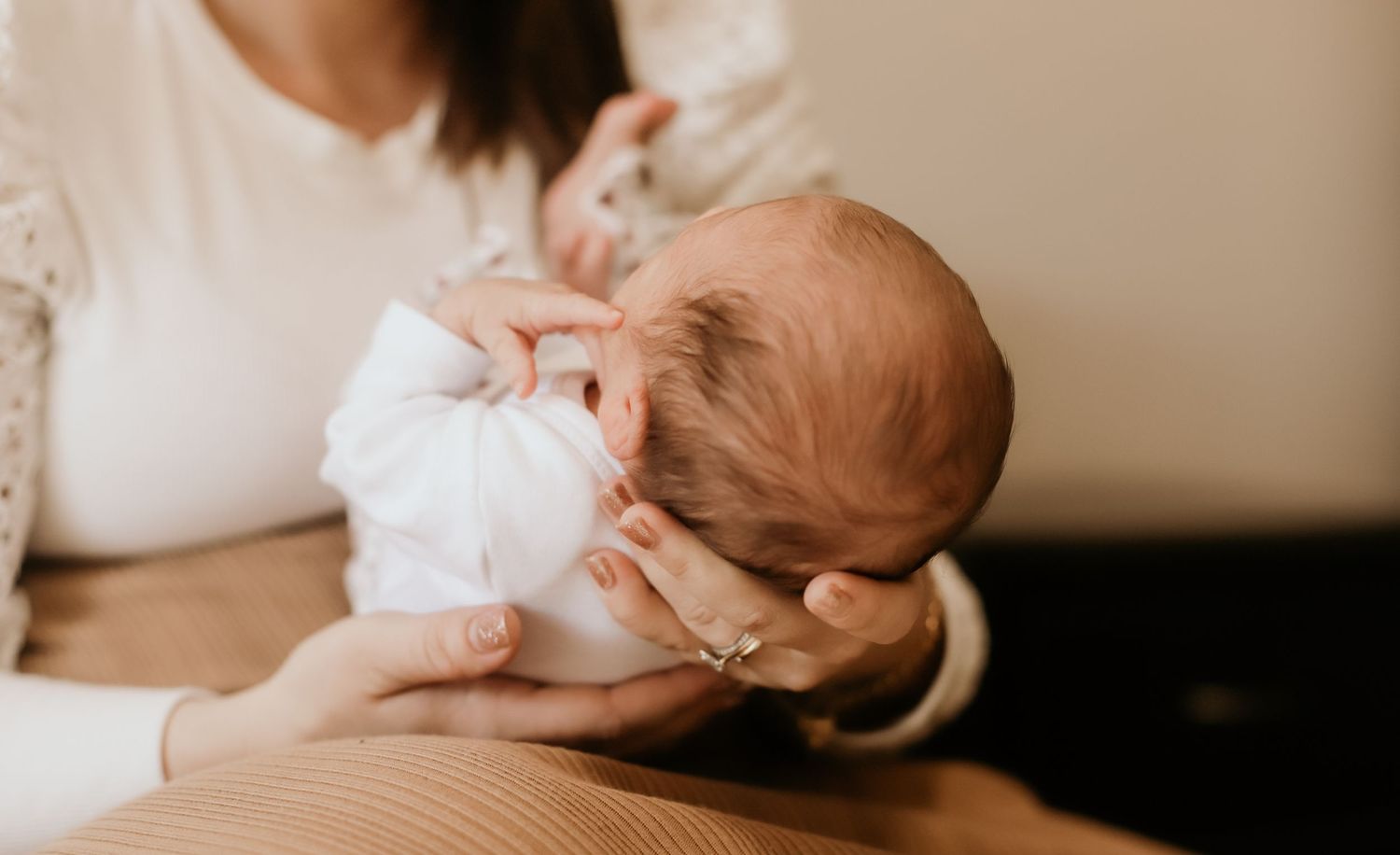 Cradling a baby in a Newborn Life Style Session.