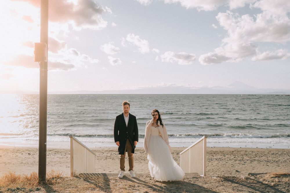 man and woman in wedding attire eloping at the beach in Seattle during sunset