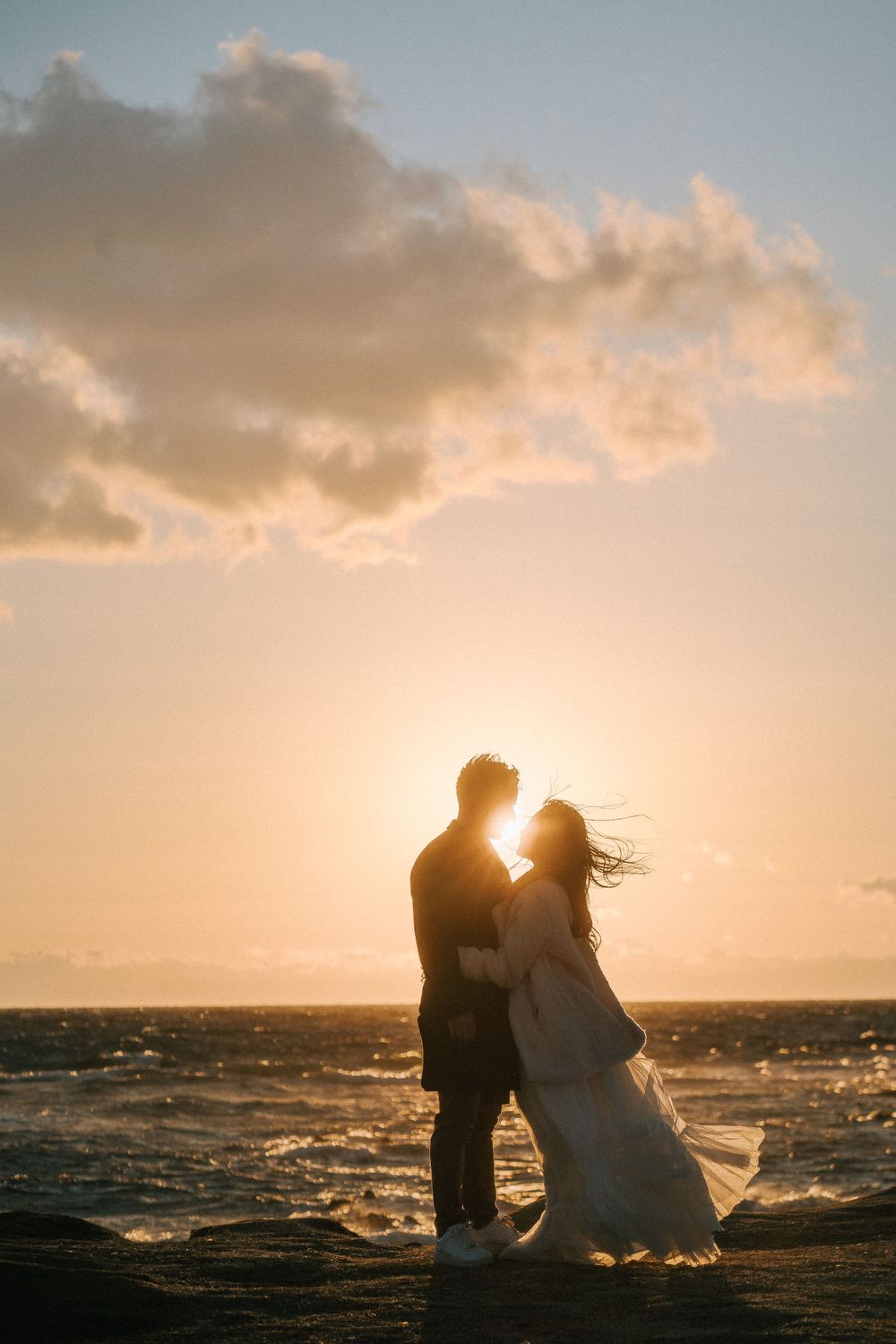 Bride and groom at the beach in Seattle during sunset