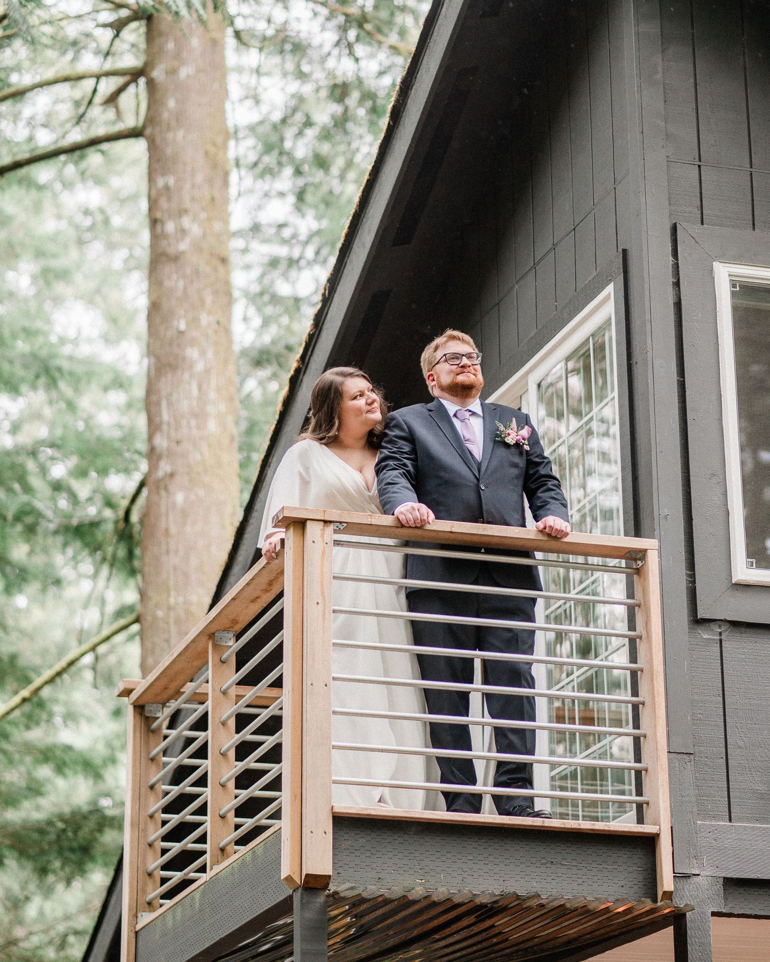 bride and groom standing on deck of Harstine Isalnd cabin.