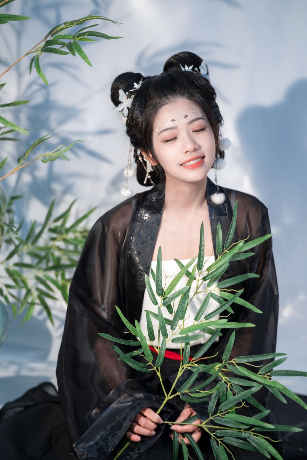 Moody studio portrait of joyful panda cosplay in black & white Hanfu with bamboo, celebrating home, by Imagine Image Studio.