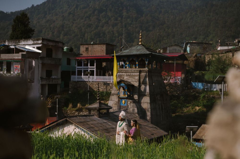Rural mountain village with traditional pagoda architecture nestled among houses.
