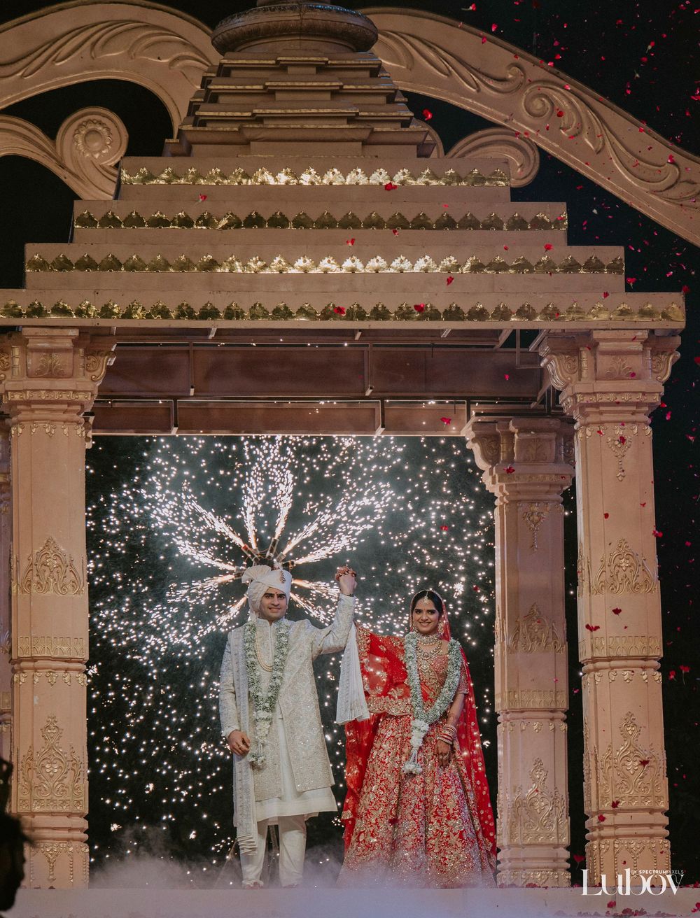 Elegant wedding ceremony setup with illuminated columns and archways creating a magical nighttime ambiance.