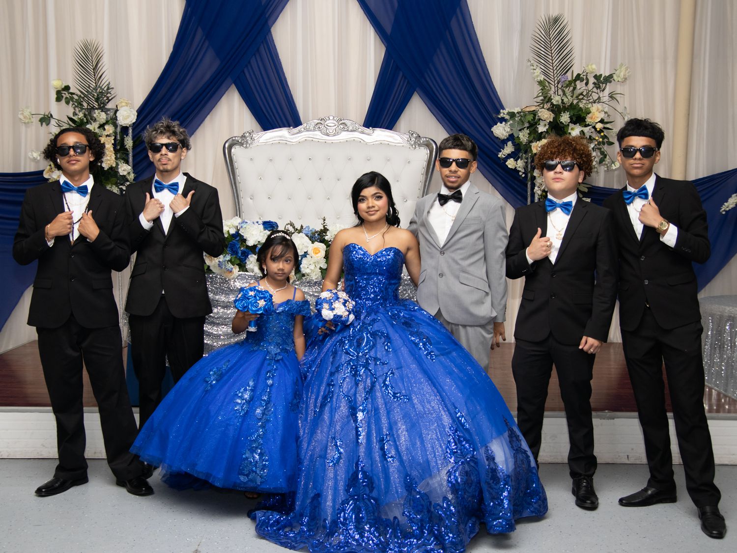 Quinceanera with blue dress with court and sister