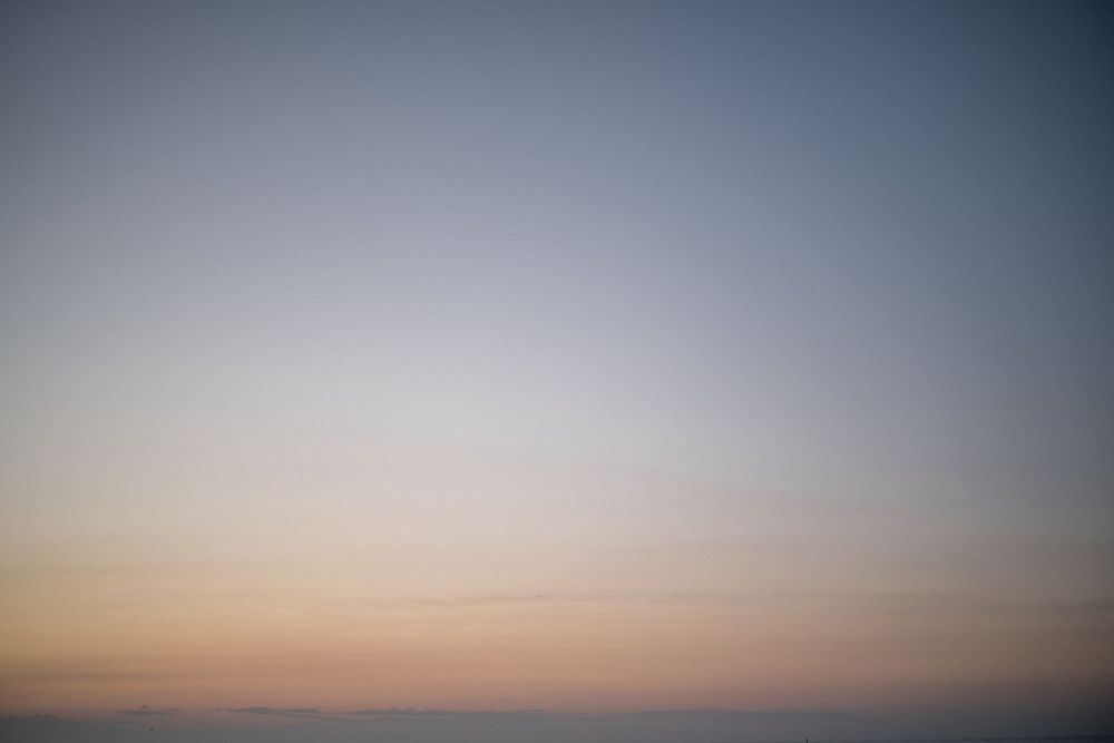 Minimal sunset sky with gradient colors fading from dark to light.