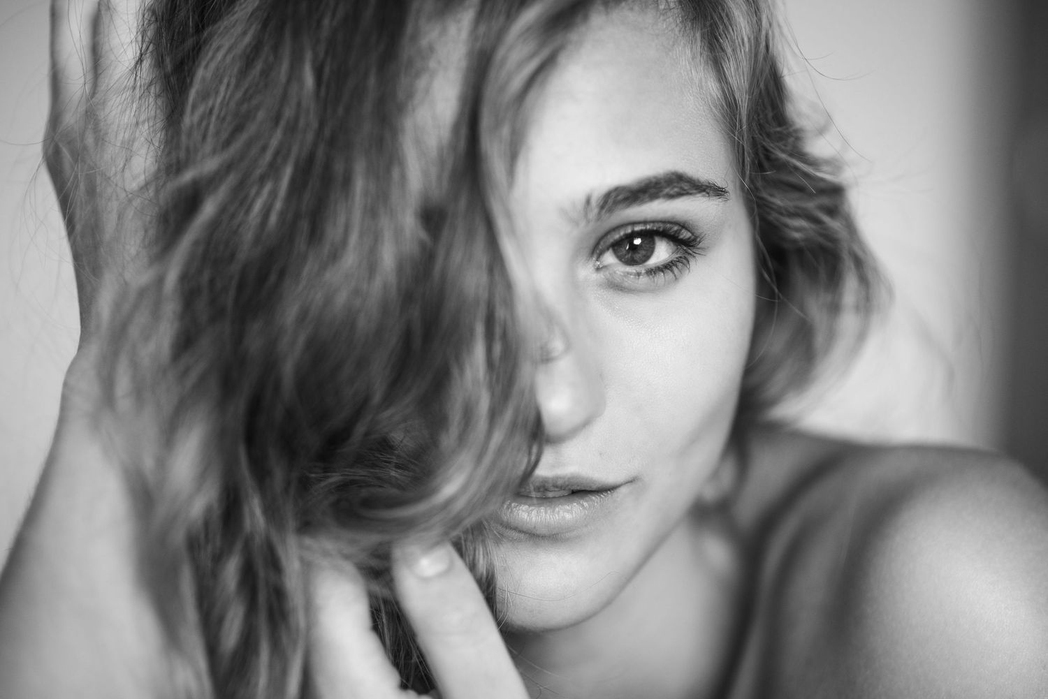 Moody black and white close-up portraits with soft focus and dramatic light.