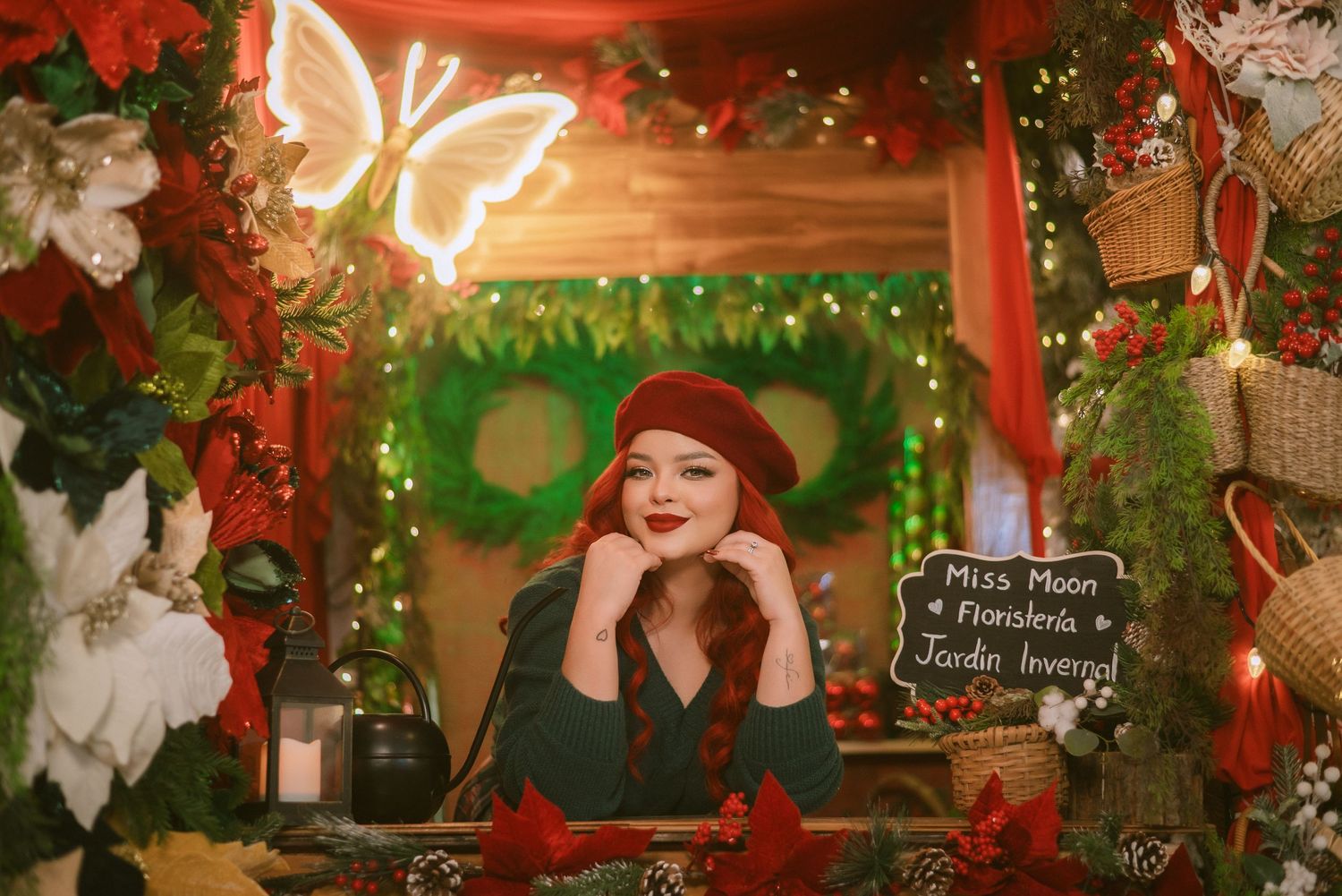 Christmas photoshoot with candy cane decorations and gingerbread house backdrop.