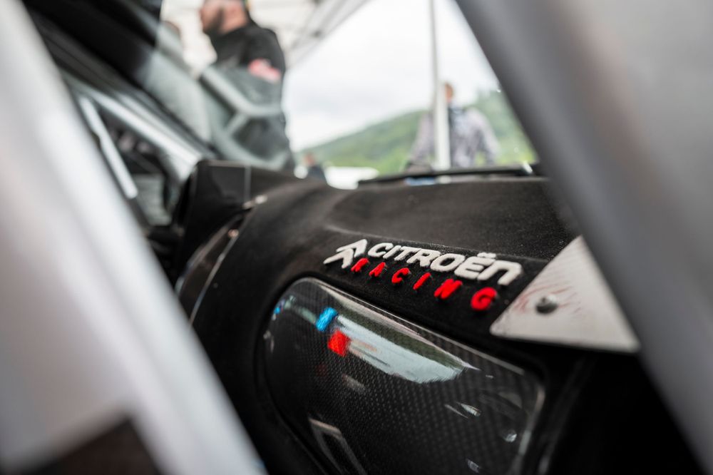 Close-up detail of performance vehicle dashboard with Citroen Racing branding.
