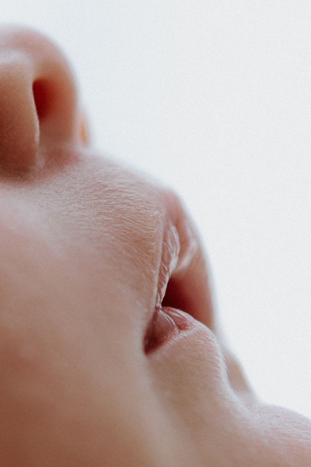 A series of close-up macro photographs showing abstract forms of human skin and body parts.