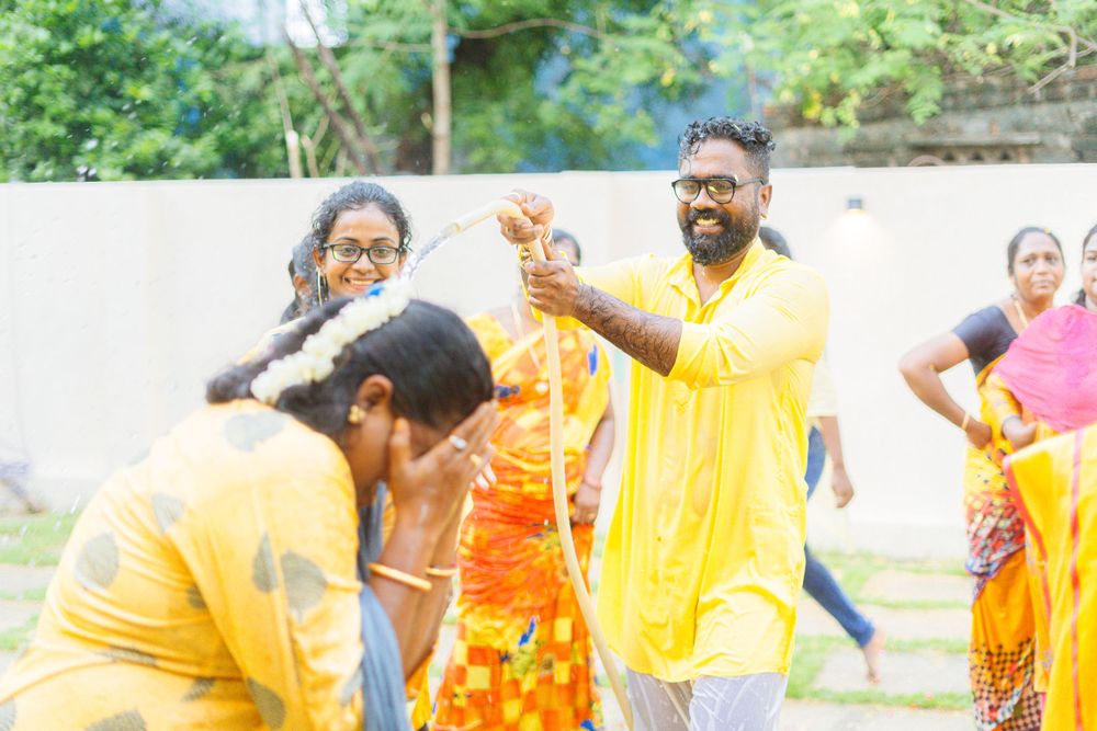 Celebrants in vibrant yellow attire enjoying festivities in an outdoor setting.