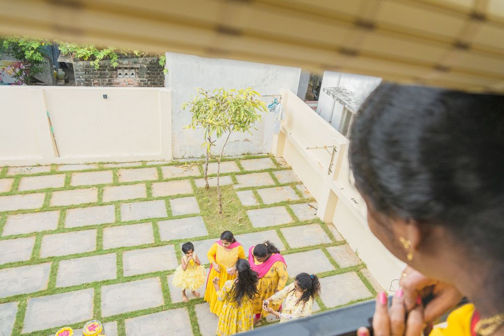 View from above showing ceremony preparations and yellow-clad participants.