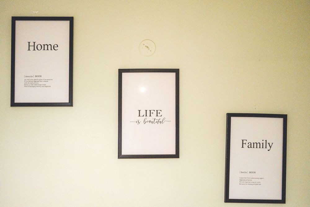 Three framed wall art prints displaying 'Home', 'Life' and 'Family' text.