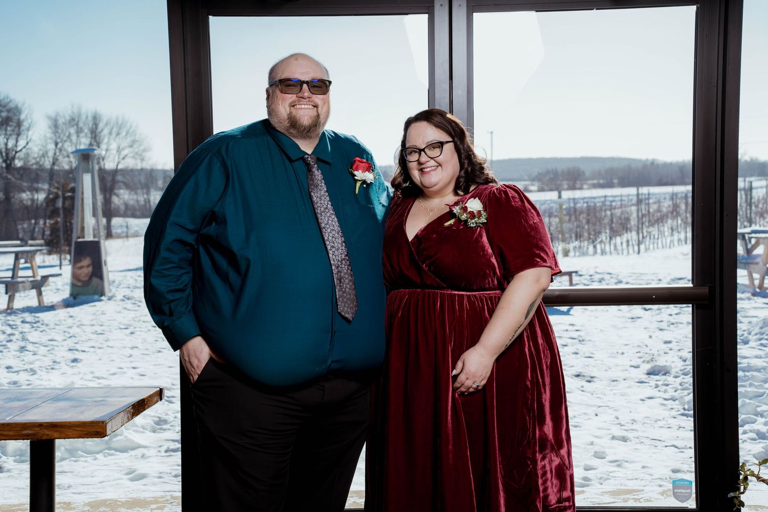 A bride and groom pose for photos with their wedding party