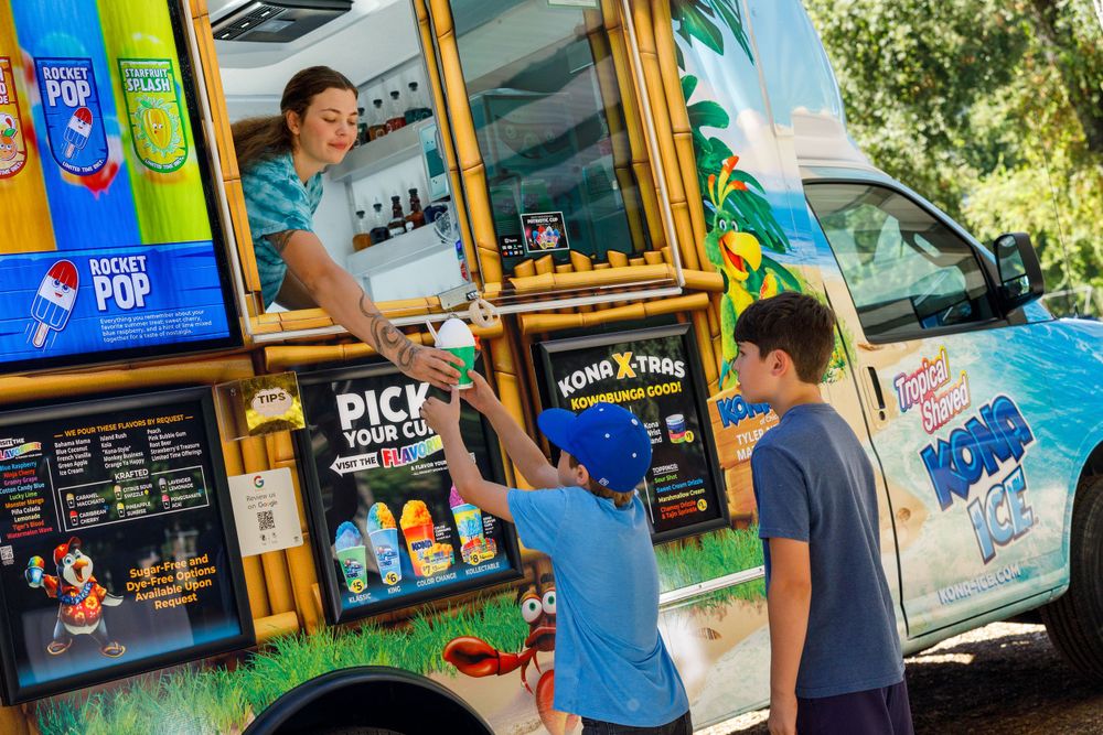 Colorful food truck serving customers on a sunny day outdoors.