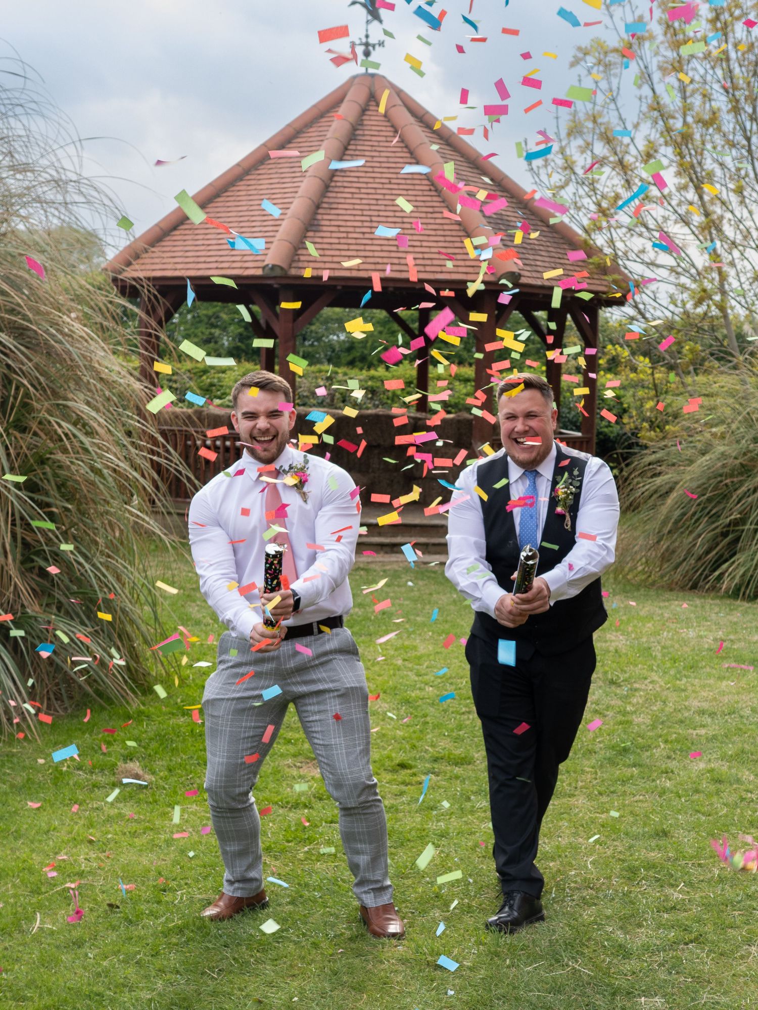 Fishlake Mill Doncaster - Wedding party throwing colorful confetti in celebration outside a brick house.