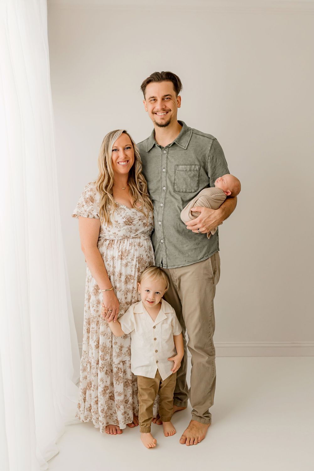 Beautiful family portrait with newborn baby in studio setting at Flowertown Photography in Summerville SC