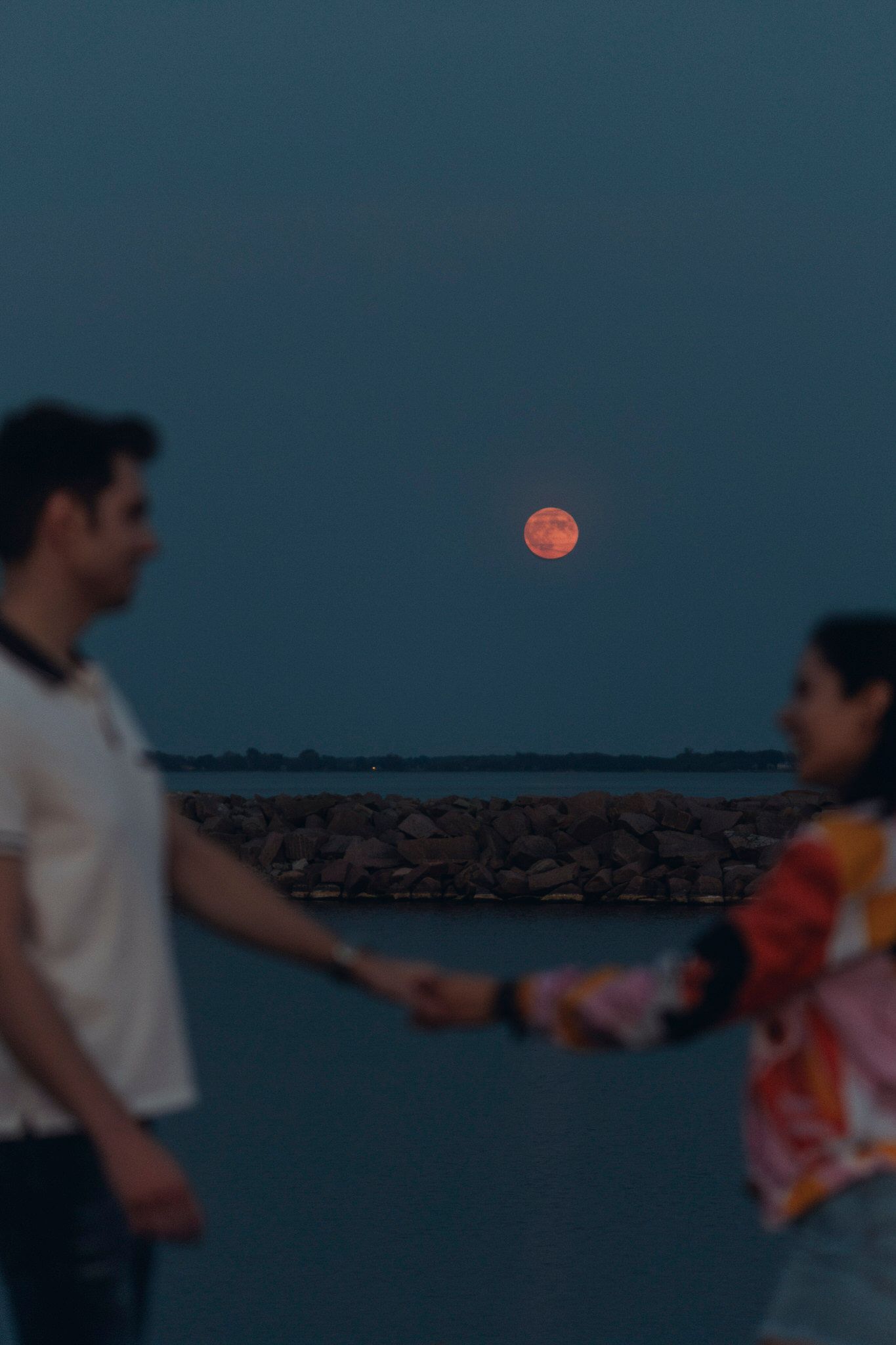 Elopement adventure: eloping couple laugh, face to face, during sunset. Kingston. Ontario. Canada
