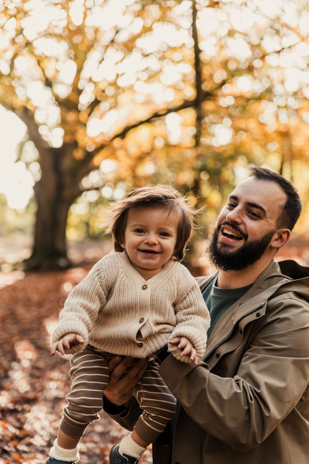 Joyful autumn moment between parent and child wearing matching knit sweaters.
