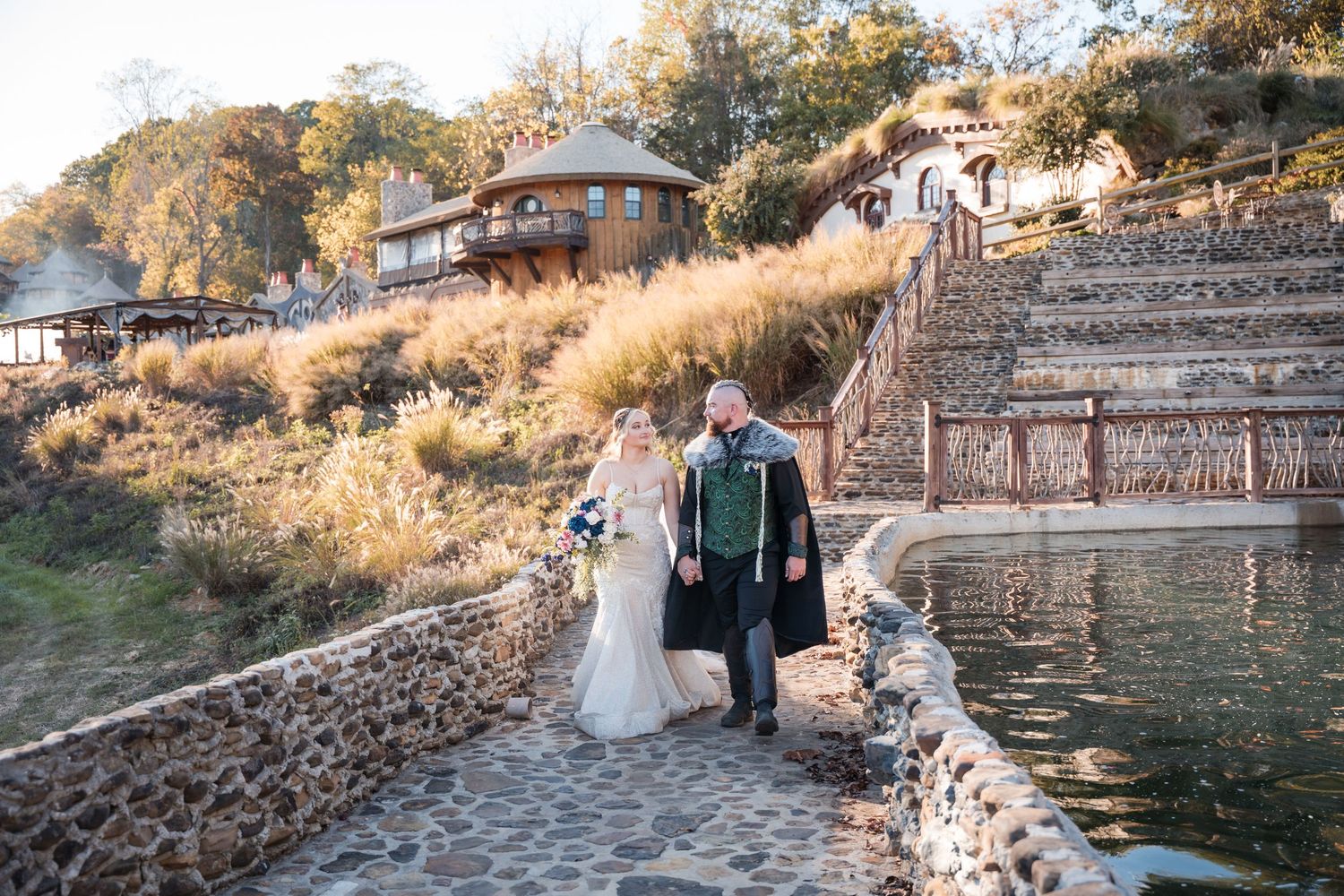 Newlyweds share intimate moment on sunlit forest road with trailing white dress.
