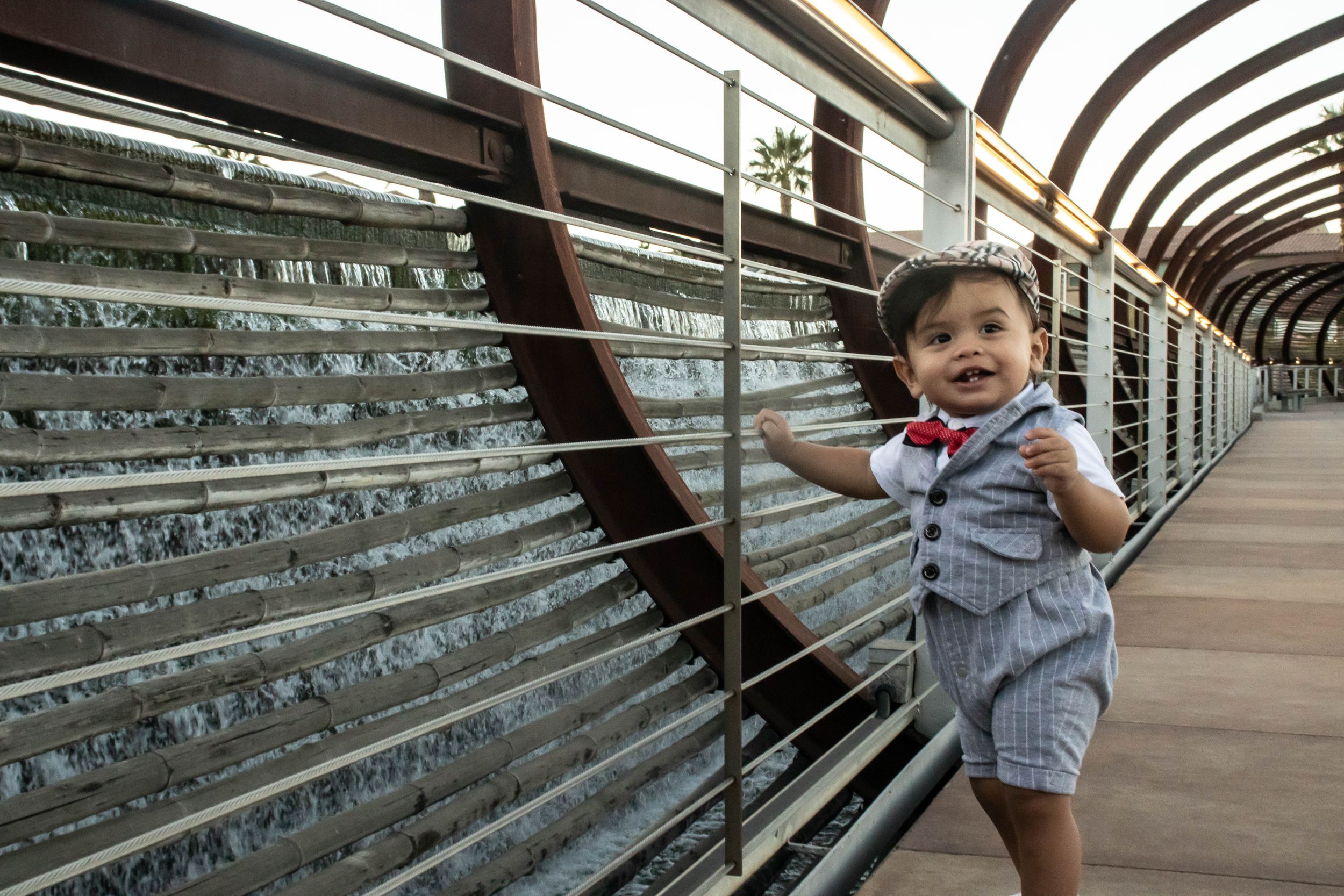 Architectural detail of curved walkway with metal railings and geometric patterns.