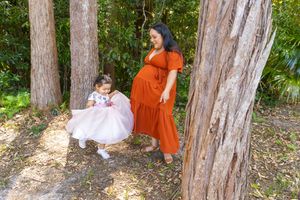 Artistic photo series showing interaction between figures in orange and white outfits in a forest setting.
