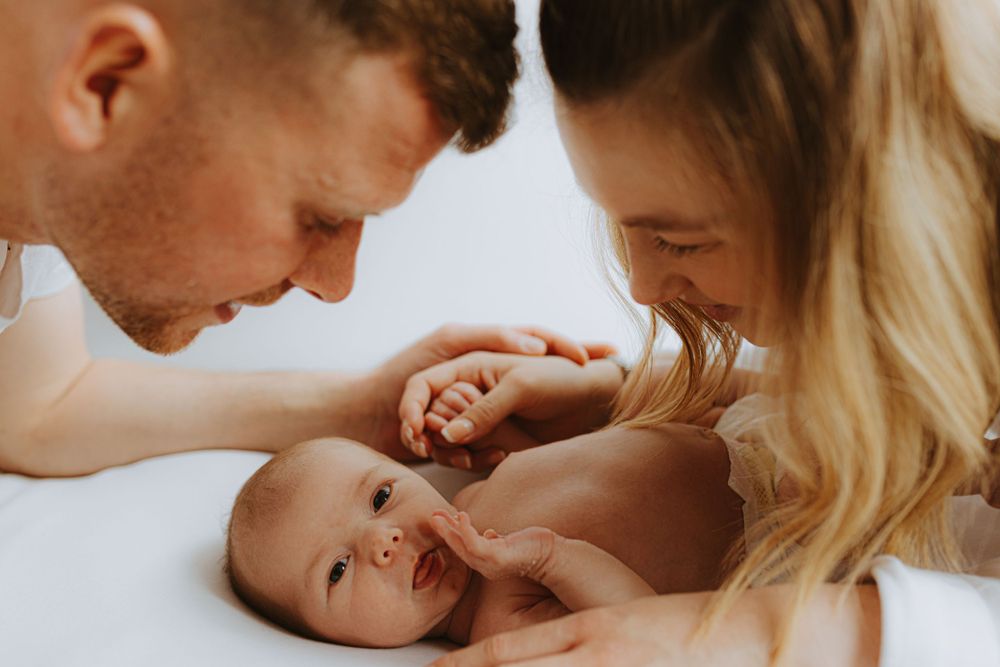 Intimate family moment with newborn baby during lifestyle photography session.