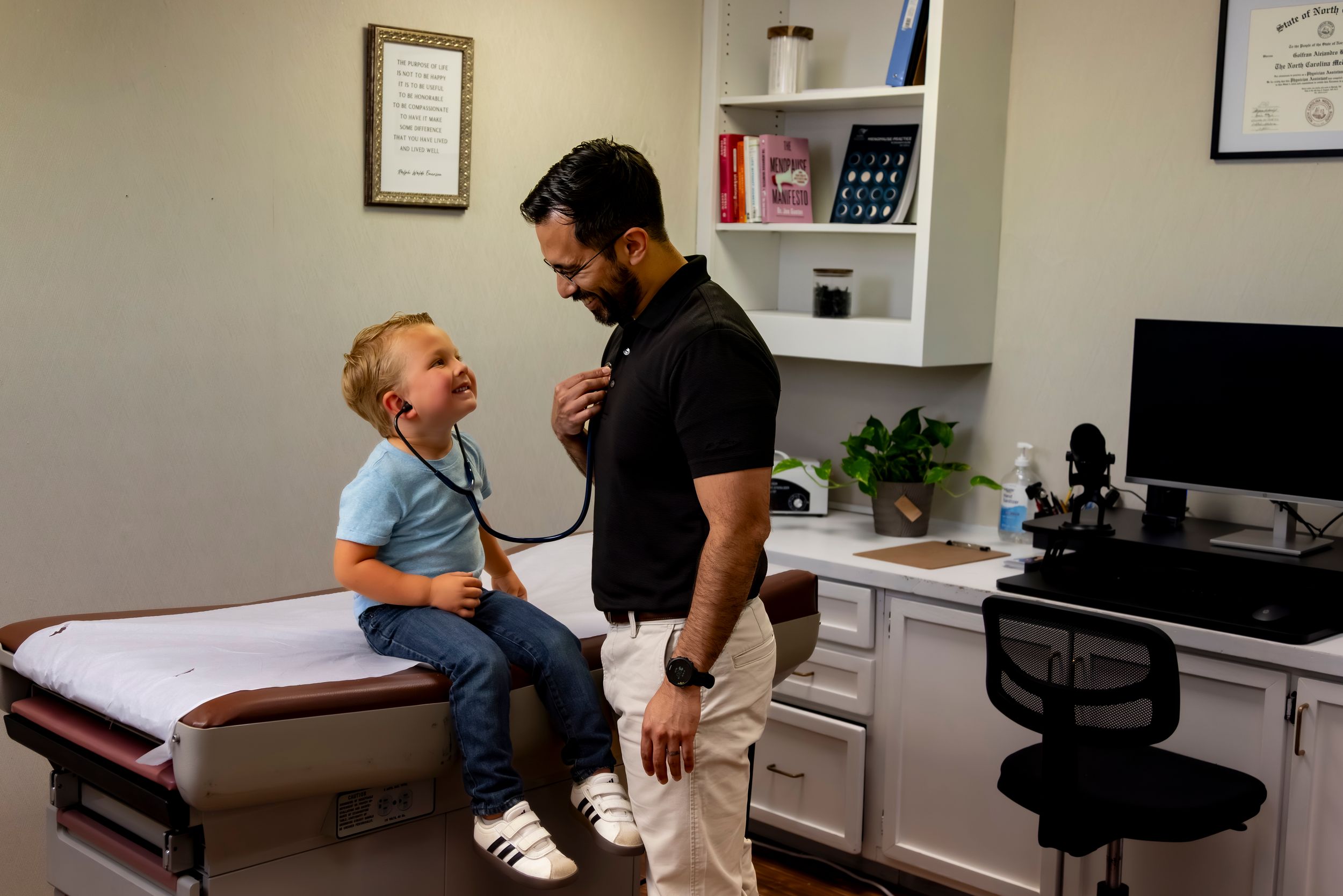 A medical provider examines a young patient during a routine check-up in a modern medical office.