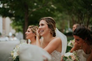 A joyful moment captured during the wedding celebration with white floral bouquets.