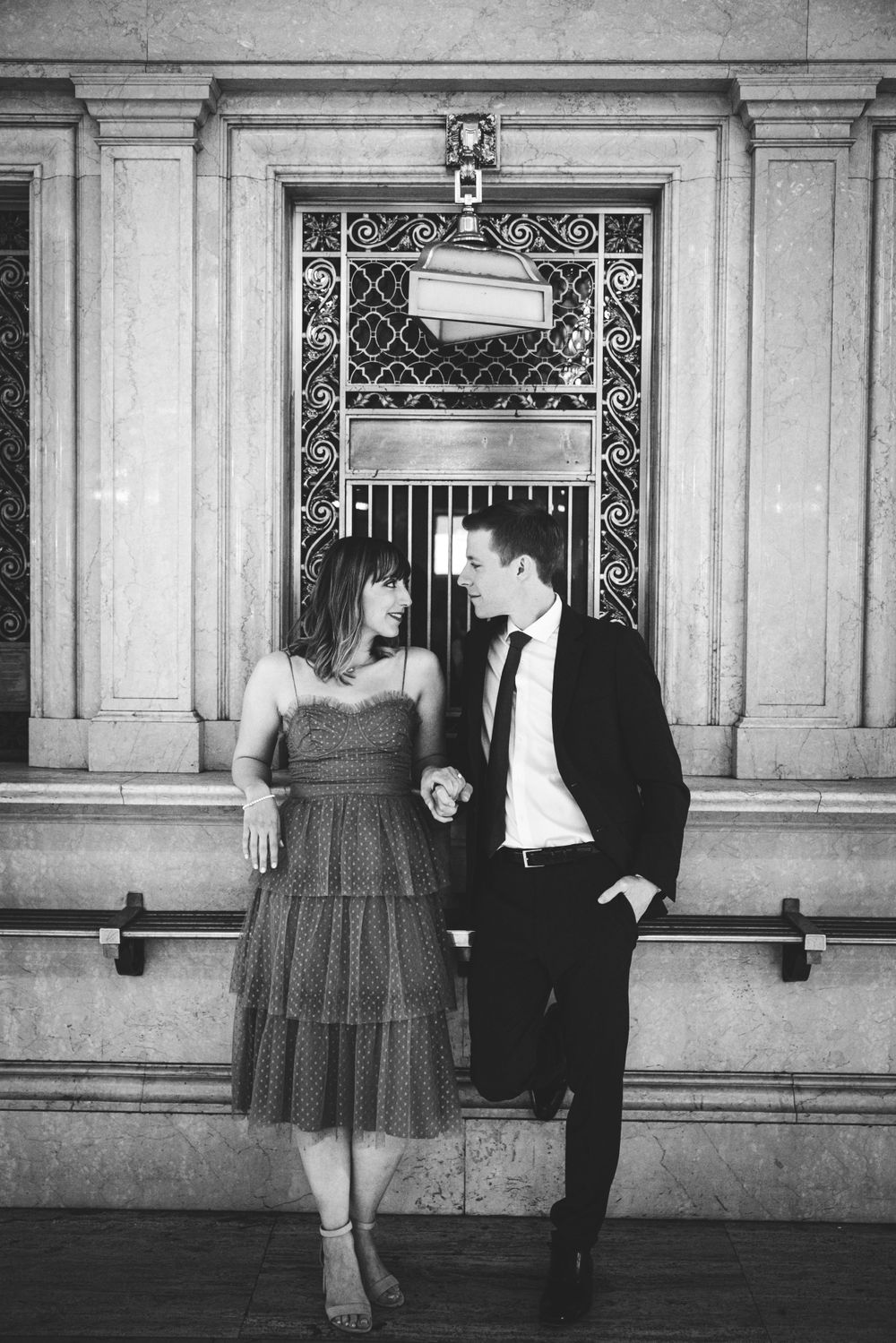 Black and white vintage photo series showing a couple dancing together in an elegant hallway.