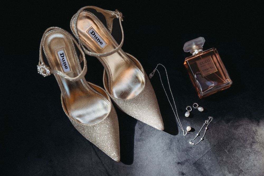 Beautiful detail shot of brides shoes, jewelry and perfume at Suffolk Wedding