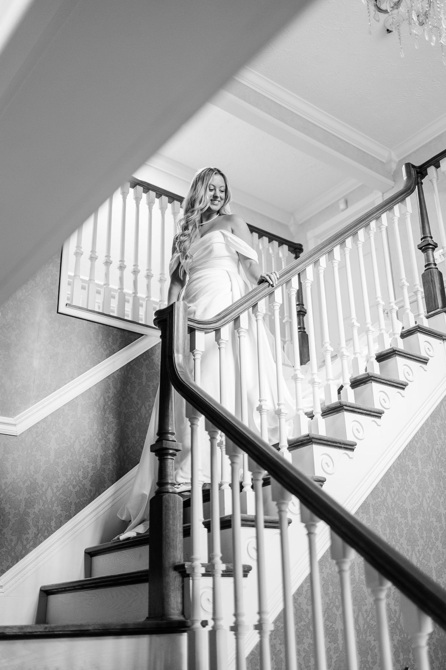 A dramatic black and white staircase sequence showing movement and architectural details.