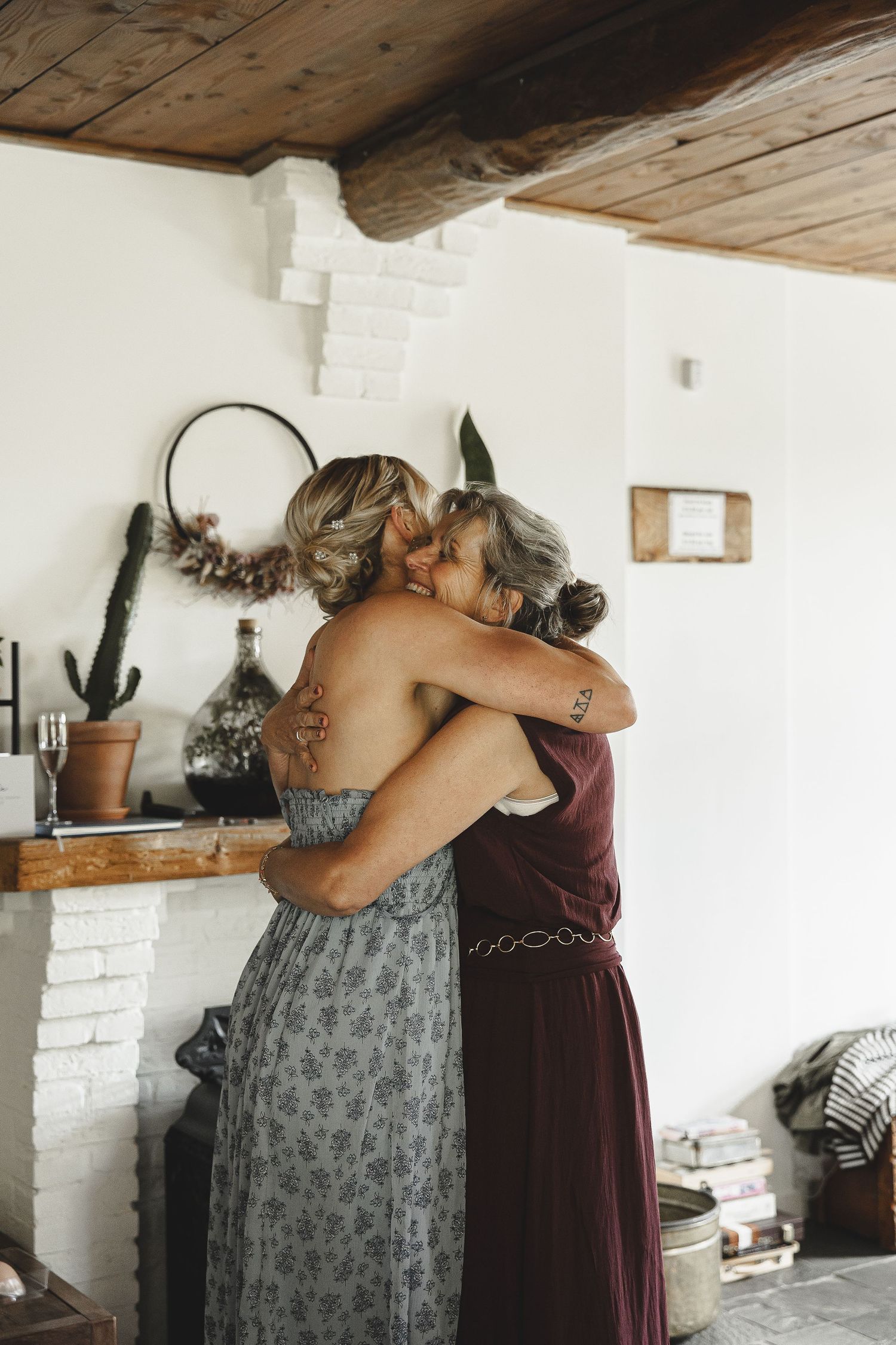 Emotional moments captured in a series showing two people embracing in a rustic room with white walls and wooden ceiling.