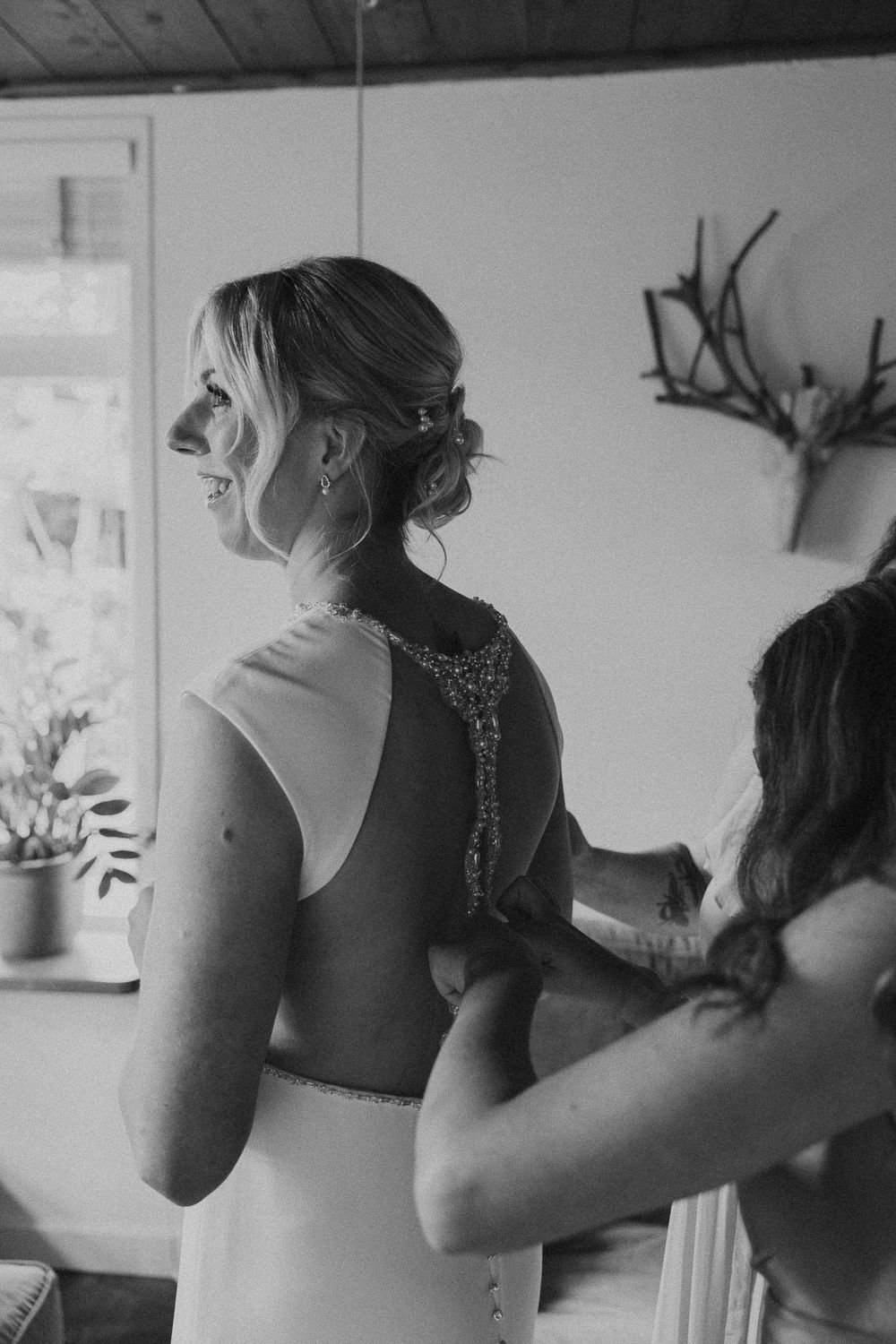 Black and white photo series showing women getting ready in formal attire with sparkly details on their dresses.