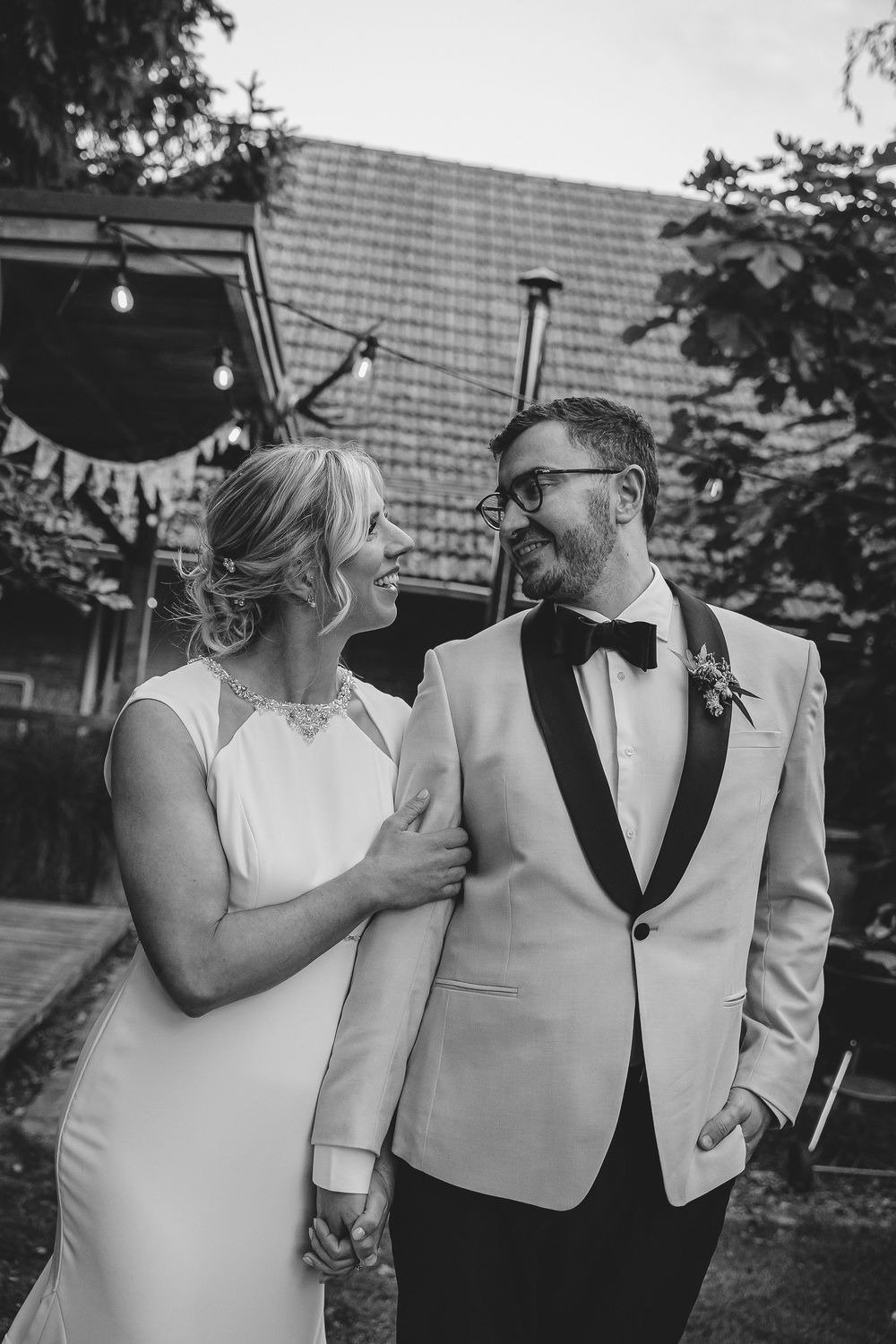A series of black and white wedding photos showing a couple sharing intimate moments in formal attire.