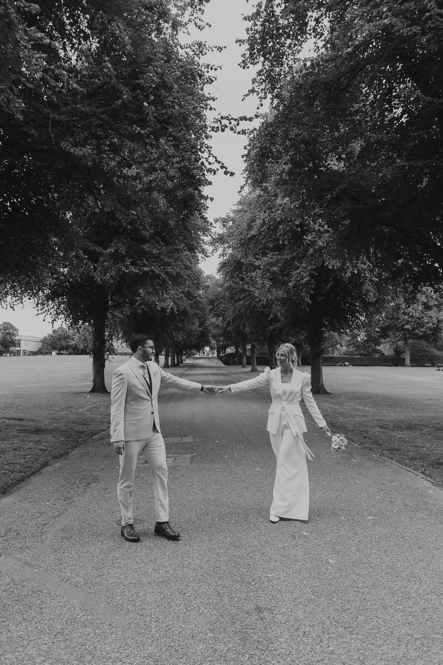 A series of artistic black and white photos showing a couple walking away in a tree-lined path.
